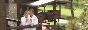 A couple wearing signature apparel spa robes enjoying a morning coffee on their balcony at the Lodge at Torrey Pines